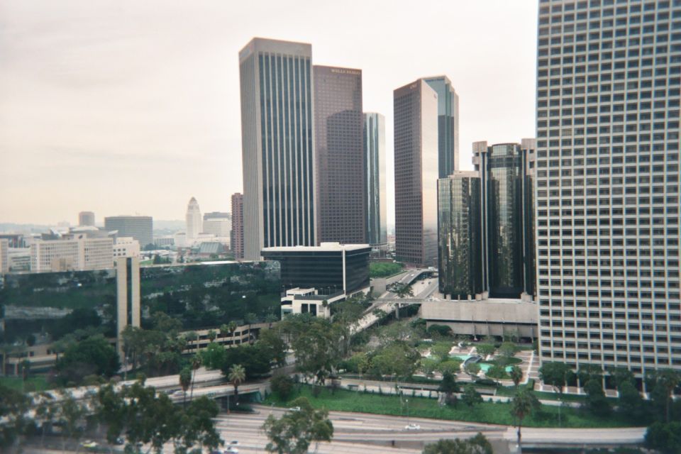 Elevated view of clustered downtown skyscrapers with landscaped plazas and roads