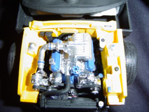 1979 Ford Bronco - Model car engine bay detail with a supercharged engine and visible hoses.