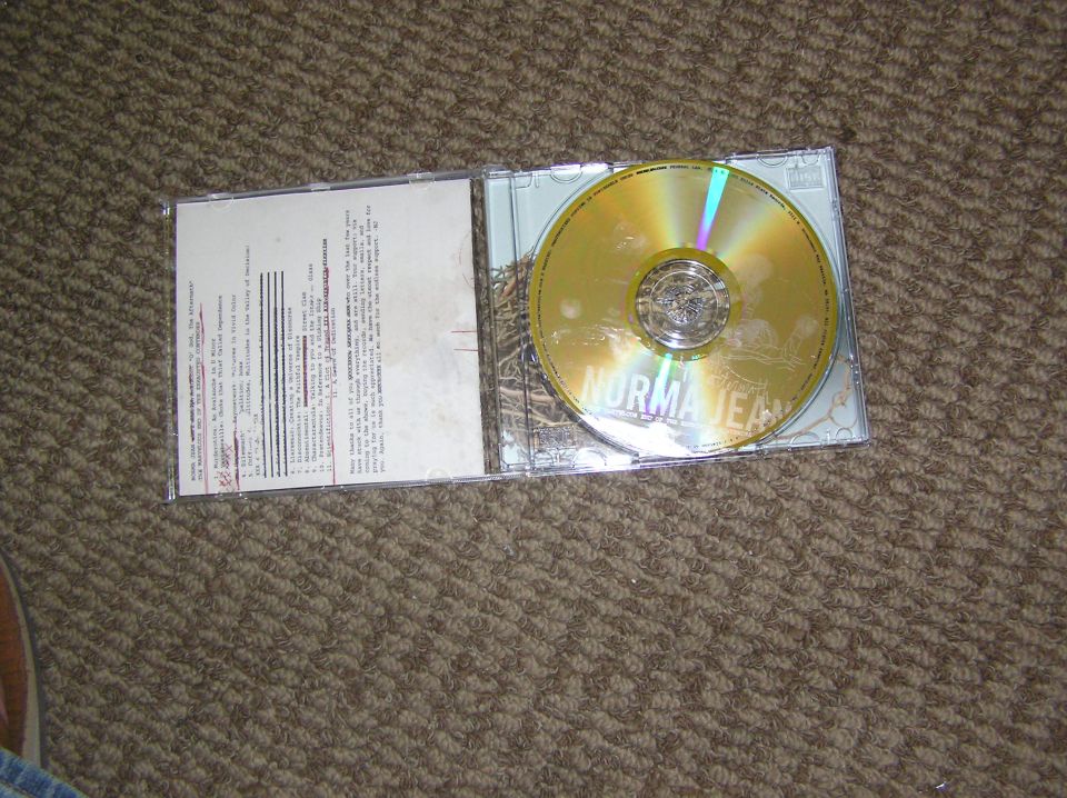 CD jewel case open, showing booklet with text and a gold disc labeled NORMA JEAN