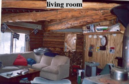 1995 Ford Bronco - Interior of a log cabin living room with furniture and a wood stove.