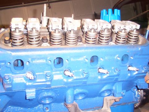 1968 Ford Mustang - This is a close-up view of an engine's cylinder head, showing internal components like spark plugs and valve springs.