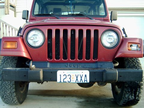 1998 Jeep TJ - Front view of a red Jeep Wrangler, likely a 1997 model, showing its iconic grille and headlights.