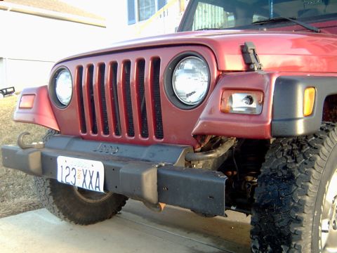 1998 Jeep TJ - The iconic seven-slot grille of a Jeep Wrangler is visible on the front of the vehicle.