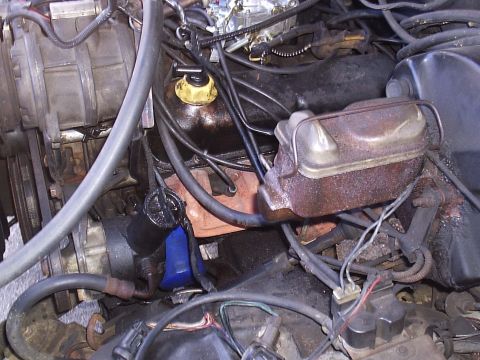 1985 Ford Bronco - Close-up view of a vehicle's engine bay, showing various components and wiring.