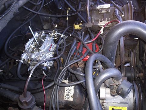 1985 Ford Bronco - Close-up of an engine bay, a carburetor and distributor. Part number FK408 is visible.