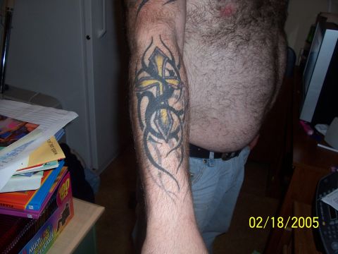 1989 Ford Bronco - Tattoo on arm with tribal design and a cross symbol.