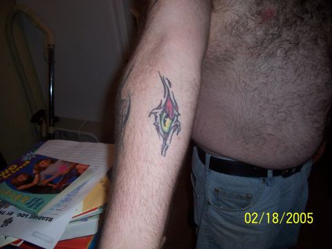 1989 Ford Bronco - A tattoo is visible on a person's arm, alongside books and a fan, with a date stamp of 02/18/2005.