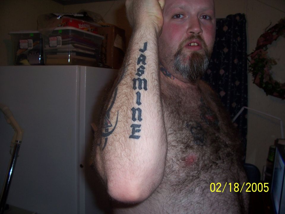 Man with 'JASMINE' tattooed on his arm, dated 02/18/2005