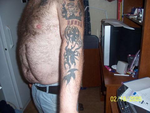 1989 Ford Bronco - A man displays his tattoos, with a dated "Supermotors.net" watermark visible in the corner of the image.