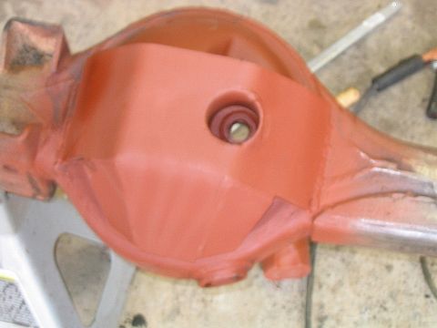 1986 Ford F-150 - Differential housing painted orange, likely for a truck or SUV, is shown on a jack stand.