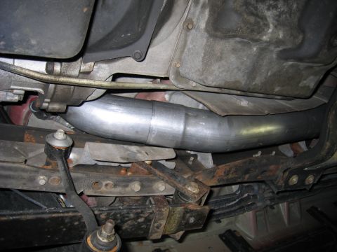 2000 Ford Excursion - Custom exhaust pipe and suspension components shown from underneath a vehicle.