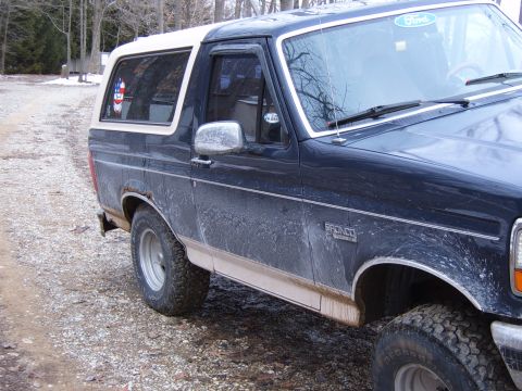 1993 Ford Bronco - The side profile of a Ford Bronco shows its distinctive body style and a "Bronco" badge on the fender.