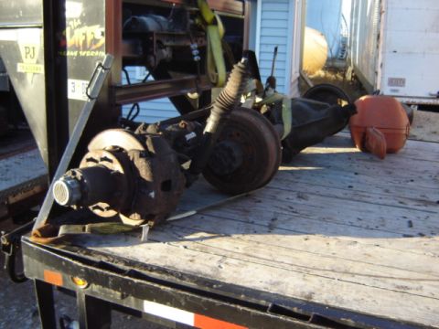 1992 Ford Bronco - A disassembled axle assembly, likely from a truck or SUV, is secured to a trailer for transport.