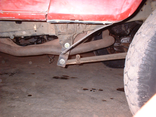 Red truck leaf spring and exhaust pipe detail