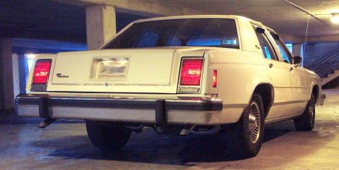 1985 Ford Crown Victoria LTD - Rear view of a 1985 Ford Crown Victoria LTD, showing its distinctive taillights and chrome bumper.