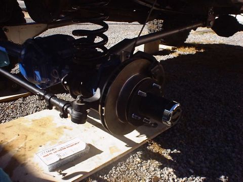1988 Ford Bronco - A detailed view of a vehicle's suspension and braking components, with some text visible on a nearby box.
