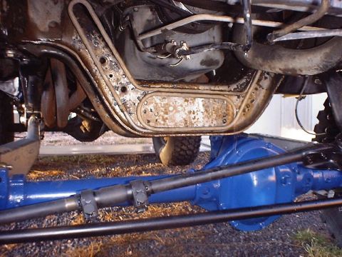 1988 Ford Bronco - Close-up view of the undercarriage, highlighting the frame and freshly painted differential.
