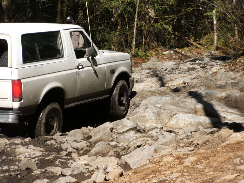 White Ford Bronco navigating a difficult rocky off-road trail
