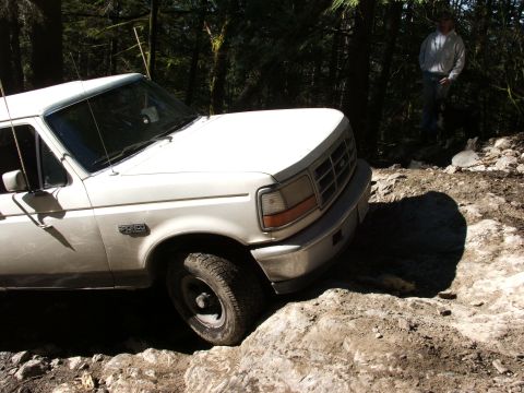 1980 Ford Bronco - This Ford Bronco is navigating a rocky off-road path in a forest setting.