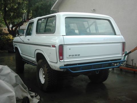 1978 Ford Bronco - This white 1978 Ford Bronco is viewed from the rear, showing its lifted suspension and custom bumper.