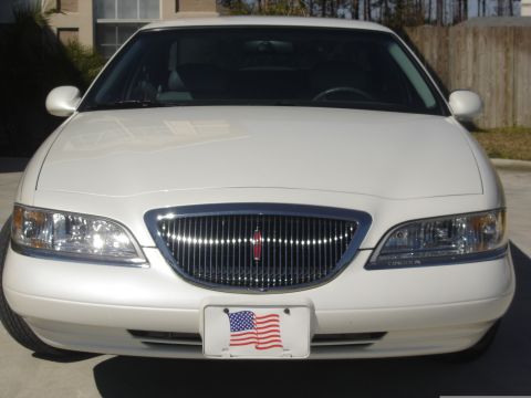 1997 Lincoln Mark VIII - Frontal view of a white 1997 Lincoln Mark VIII, displaying its distinctive grille and headlights.