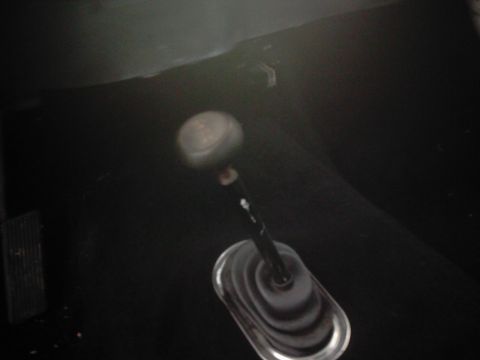 1978 Ford Bronco - Close-up view of a gear shift lever within a vehicle's interior.