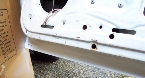 1985 Ford Crown Victoria LTD - Close-up view of the interior of a car door, revealing internal components and wiring.