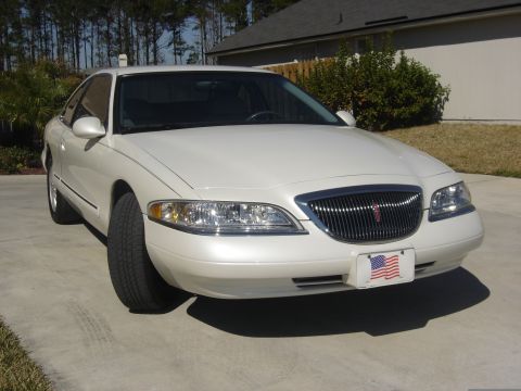 1997 Lincoln Mark VIII - A white 1997 Lincoln Mark VIII is shown from the front 3/4 angle on a sunny day.