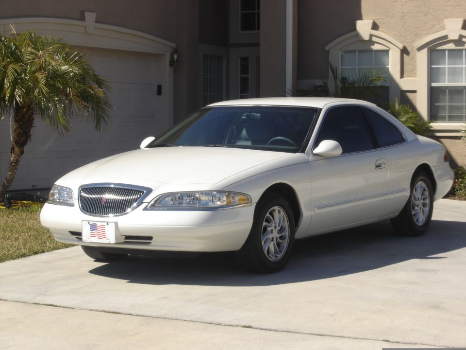 White 1997 Lincoln Mark VIII coupe parked in driveway