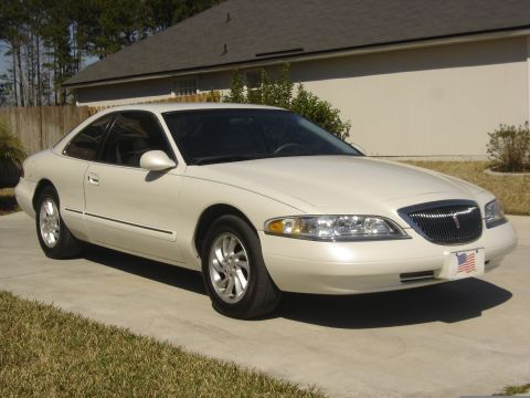 1997 Lincoln Mark VIII - A white 1997 Lincoln Mark VIII coupe is shown from the front 3/4 angle on a sunny day.