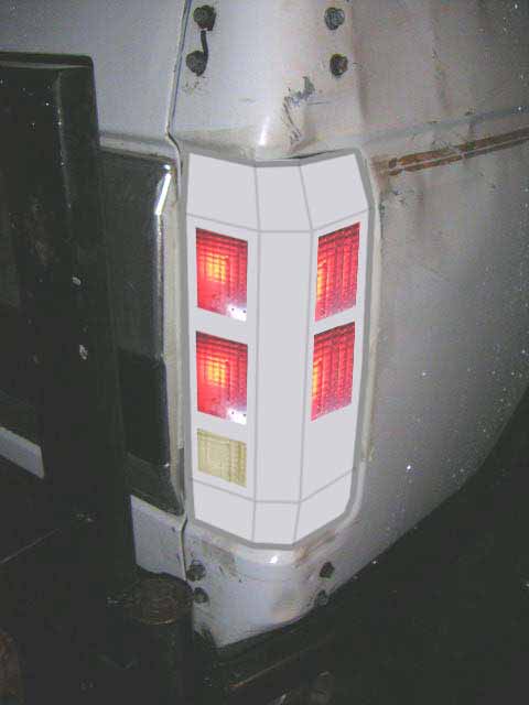 1993 Ford Bronco - A close-up view of a vehicle's rear tail light assembly with a white overlay.