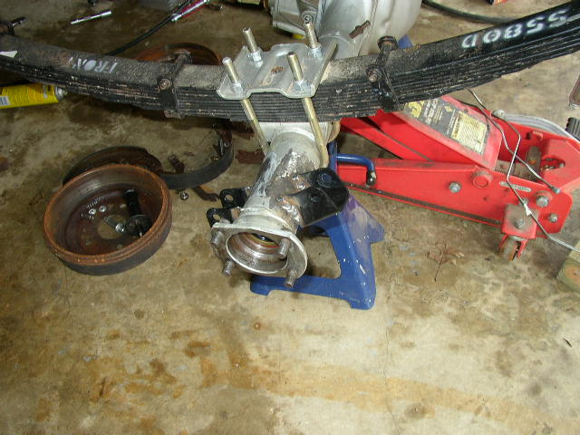 Leaf spring assembly with brake drum and hub, supported by jack stands