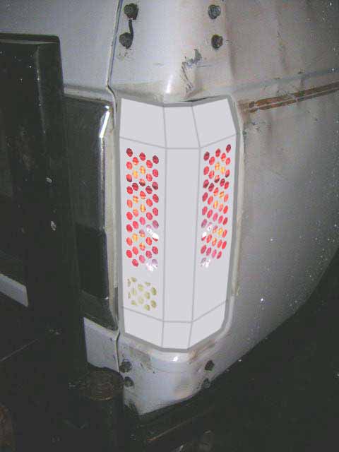 1993 Ford Bronco - Close-up of the rear tail light assembly on a white Ford Bronco from the 1980s.