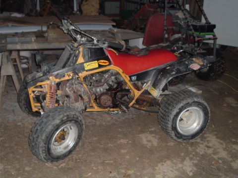 1995 Mercury Grand Marquis - This ATV appears to be in a state of disrepair or modification, with its engine and frame clearly visible.