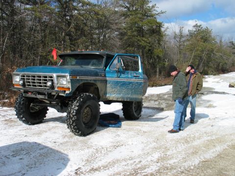 1995 Ford Bronco - Modified 1978 Ford Bronco with oversized tires sits in a snowy, wooded landscape.