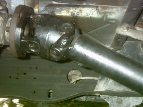 1992 Ford Bronco - Close-up view of a vehicle's driveshaft U-joint and flange assembly.