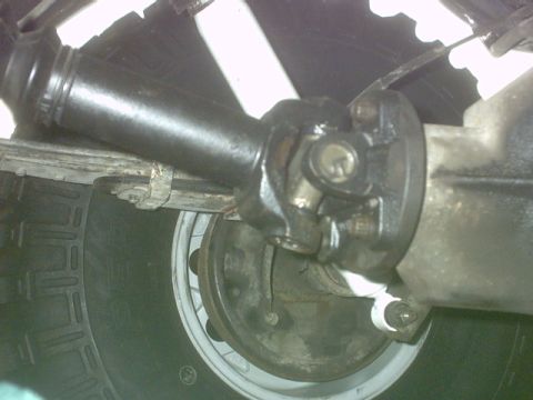 1992 Ford Bronco - Close-up view of a vehicle's driveshaft U-joint connecting to the rear differential.