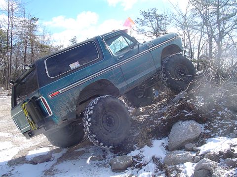 1979 Ford Bronco - This modified 1979 Ford Bronco navigates a challenging rocky incline, its off-road capabilities.