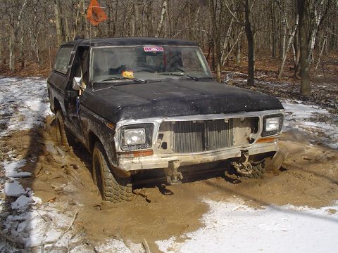 1979 Ford Bronco - This vehicle is stuck in a muddy, wooded area during winter.