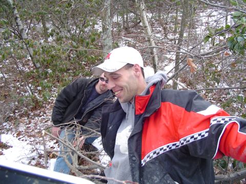 1979 Ford Bronco - Two men are in a wooded area with snow on the ground, one is smiling and wearing a red and black jacket.