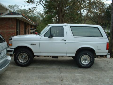 1996 Ford Bronco - This 1996 Ford Bronco is shown from the side, parked in a driveway.