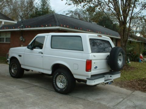 1996 Ford Bronco - This 1996 Ford Bronco is parked outside a brick house with Christmas lights on the roof.