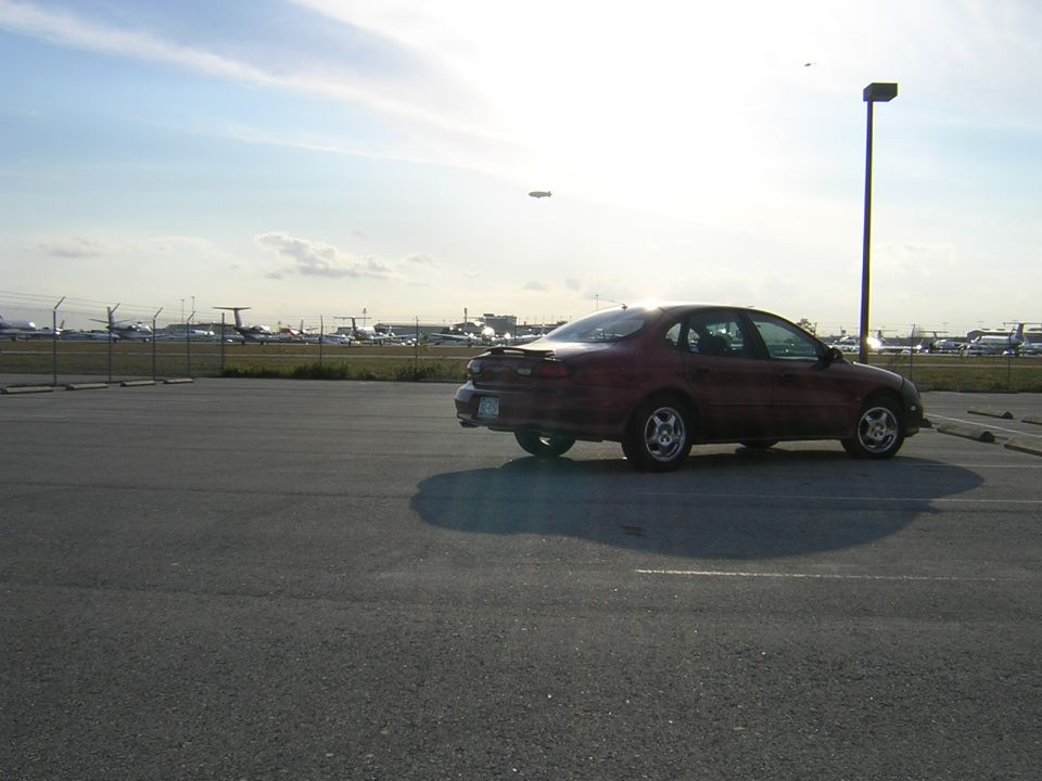 1997 Ford Taurus parked in an airport lot, side view