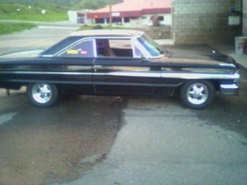 1964 Ford Galaxie - This 1964 Ford Galaxie coupe features a distinctive side profile with prominent chrome trim and custom wheels.