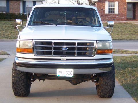 1992 Ford C-250 (Centurion Conversions) - This lifted Ford F-Series truck features a chrome grille and large off-road tires.