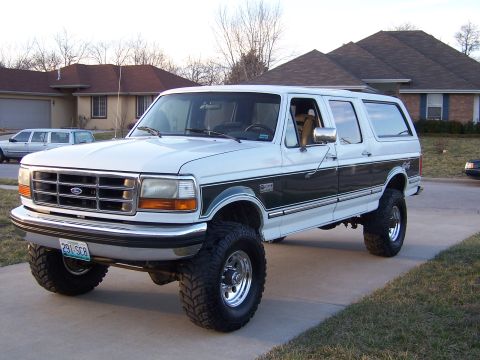 1992 Ford C-250 (Centurion Conversions) - This lifted 1992 Ford C-250 Centurion Conversions SUV is shown from the front three-quarter angle.
