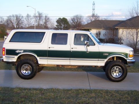 1992 Ford C-250 (Centurion Conversions) - This modified pickup truck features a custom camper shell, giving it an extended SUV appearance. The vehicle has a two-tone paint scheme an…