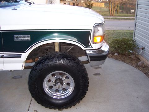 1992 Ford C-250 (Centurion Conversions) - Close-up of the front fender and large off-road tire on a 1992 Ford C-250.