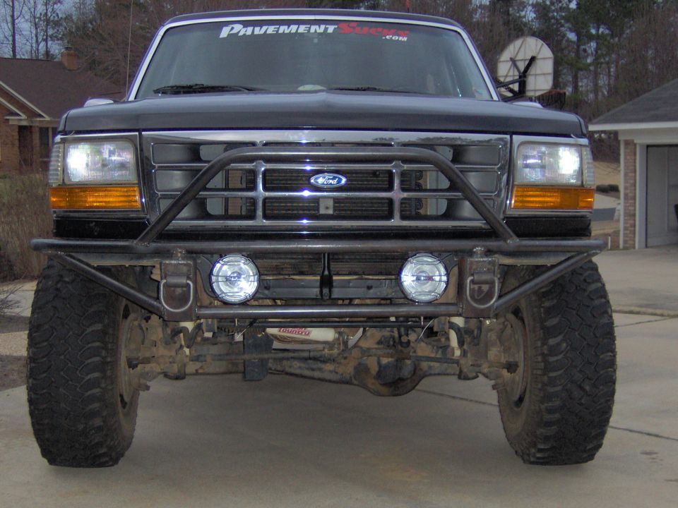 Black Ford Bronco front view with custom bumper and off-road tires