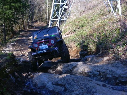 1990 Ford Bronco - This off-road vehicle tackles a challenging rocky path with a steep incline.